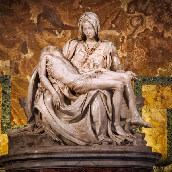 Marble statue depicting the pietà, the virgin mary cradling the body of jesus after his crucifixion.